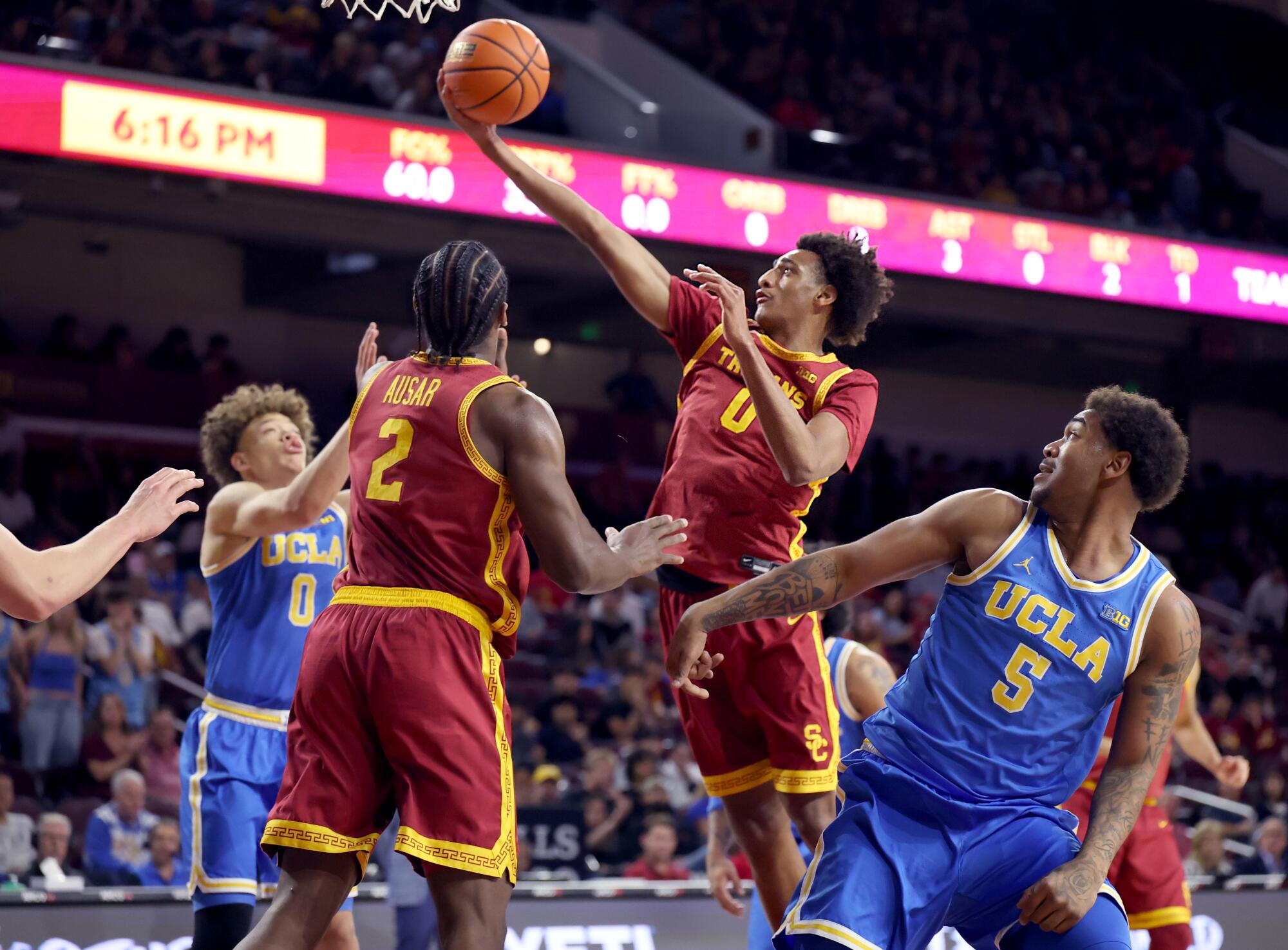 USC guard Alijah Arenas shoots in front of UCLA guards Trent Perry and Brandon Williams at the Galen Center on Saturday.
