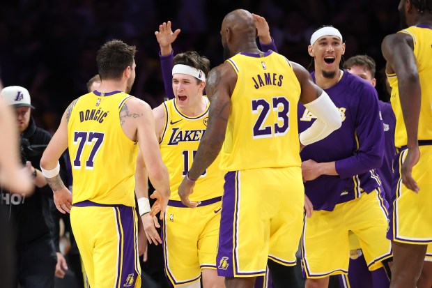 Austin Reaves congratulates Luka Doncic of the Los Angeles Lakers after his winning jumpshot defeated the Denver Nuggets 127-125 in overtime of a game at Crypto.com Arena on March 14, 2026 in Los Angeles, California. (Photo by Sean M. Haffey/Getty Images)