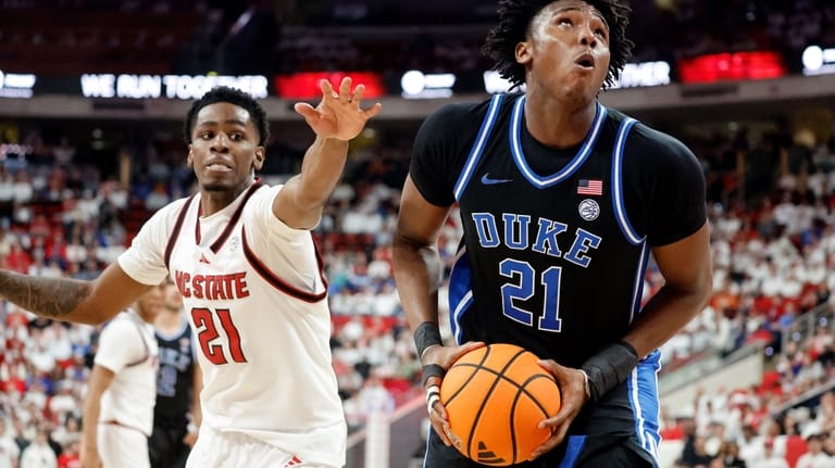 Duke's Patrick Ngongba, right, drives the ball past North Carolina...