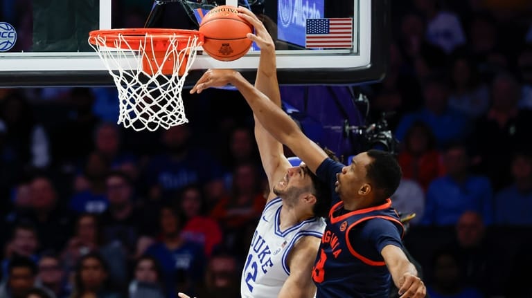 Virginia center Ugonna Onyenso, right, alters shot by Duke forward...