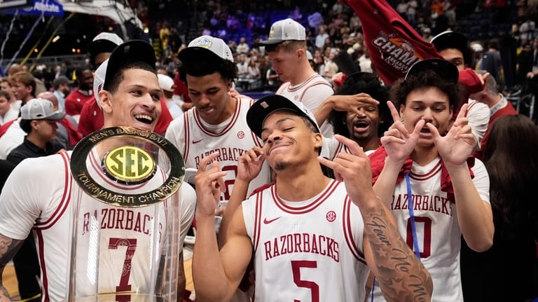 Arkansas' Trevon Brazile (7), Darius Acuff Jr. (5) and Jaden...