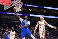 Dallas Mavericks forward Naji Marshall (13), left, shoots against New Orleans Pelicans guard...
