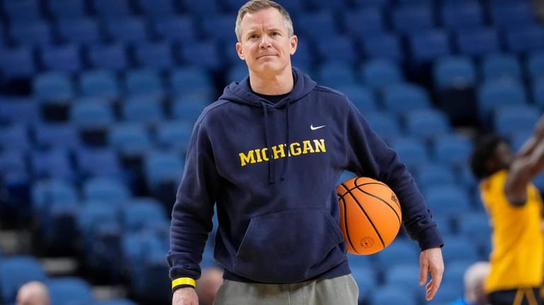 Michigan head coach Dusty May watches during practice prior to...
