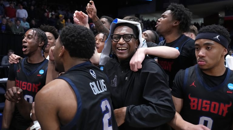 Howard head coach Kenneth Blakeney, center, and Howard players celebrate...