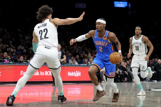 Mar 18, 2026; Brooklyn, New York, USA; Oklahoma City Thunder guard Shai Gilgeous-Alexander (2) drives to the basket against Brooklyn Nets forward Jalen Wilson (22) and guard Ochai Agbaji (30) during the second quarter at Barclays Center. Mandatory Credit: Brad Penner-Imagn Images