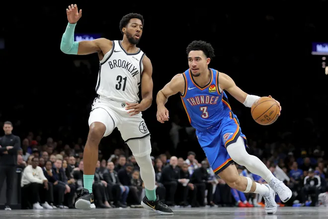 Mar 18, 2026; Brooklyn, New York, USA; Oklahoma City Thunder guard Jared McCain (3) drives to the basket against Brooklyn Nets forward Chaney Johnson (31) during the first quarter at Barclays Center. Mandatory Credit: Brad Penner-Imagn Images