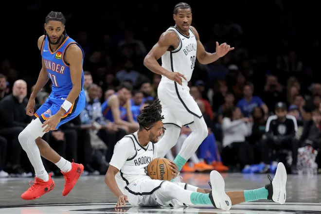 Mar 18, 2026; Brooklyn, New York, USA; Brooklyn Nets forward Ziaire Williams (1) grabs a loose ball against Oklahoma City Thunder guard Isaiah Joe (11) during the first quarter at Barclays Center. Mandatory Credit: Brad Penner-Imagn Images