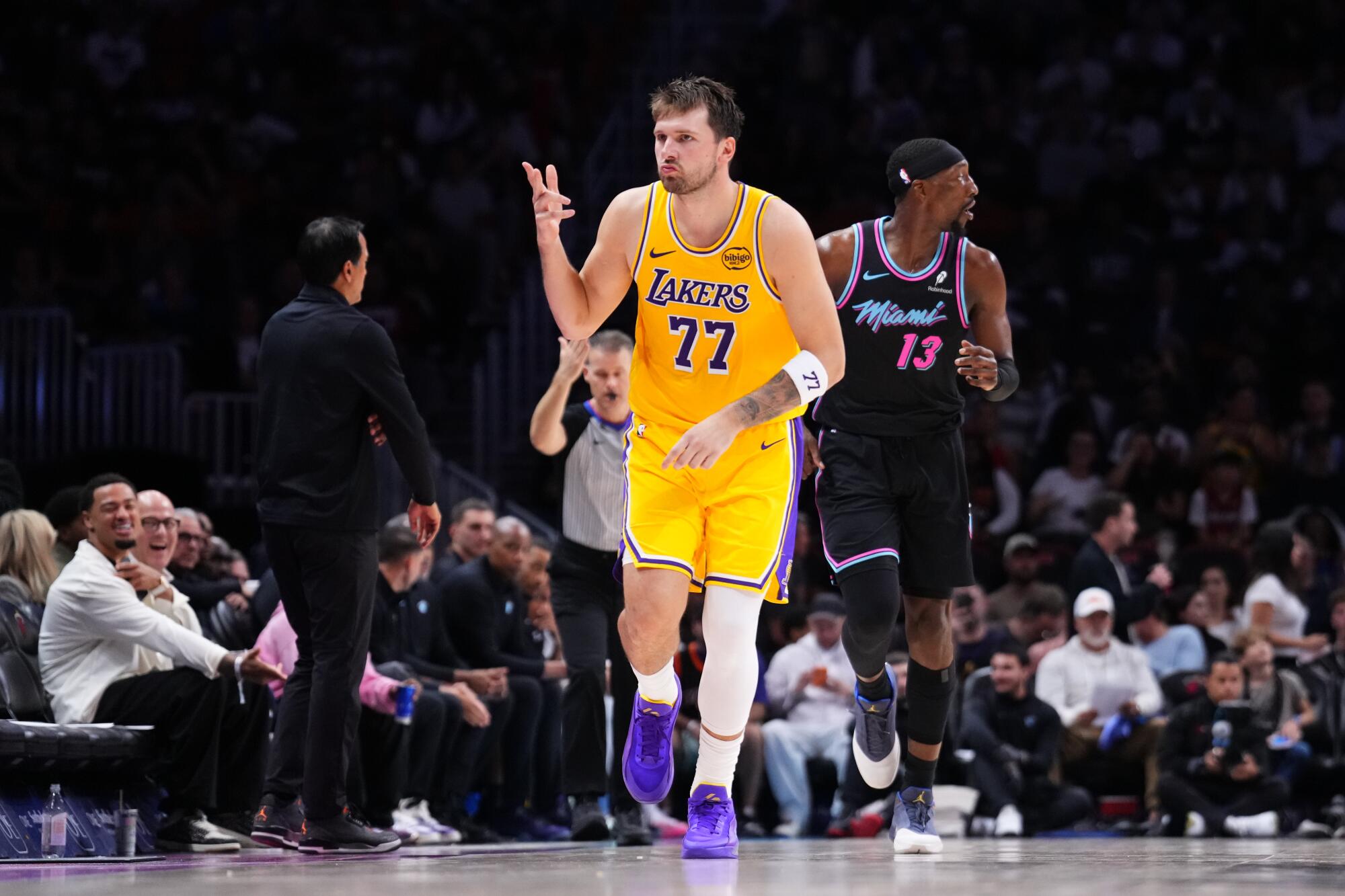 Lakers star Luka Doncic reacts after making a three-pointer in the third quarter Thursday against the Miami Heat.