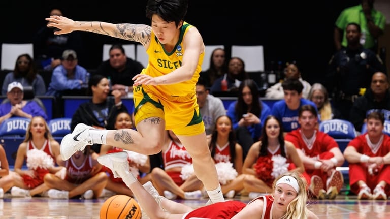 Baylor's Yuting Dent, left, leaps over Nebraska's Britt Prince, right,...