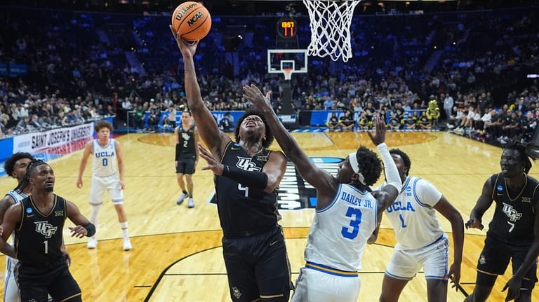 UCF's Jamichael Stillwell (4) goes up for a shot against...