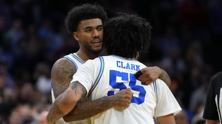 UCLA's Donovan Dent, left, and Skyy Clark embrace after winning...