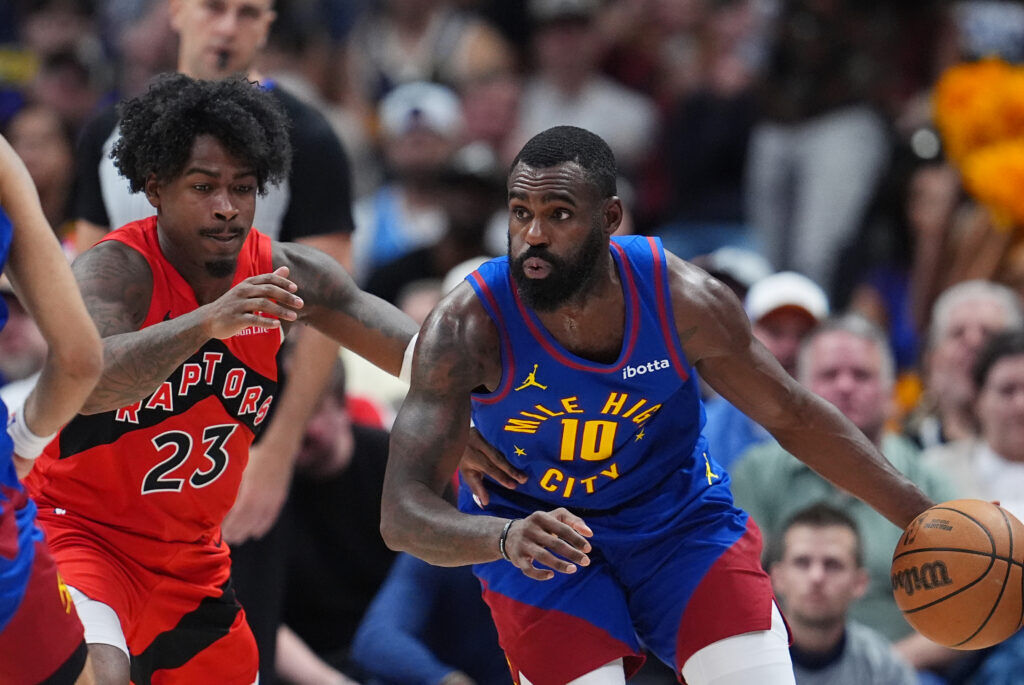 Denver Nuggets guard Tim Hardaway Jr., back, gestures to call a time out at Toronto Raptors head coach Darko Rajakovic after Hardaway's 3-point basket late in the second half of an NBA basketball game Friday, March 20, 2026, in Denver. (AP Photo/David Zalubowski)