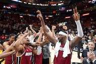 Miami Heat center Bam Adebayo, right, celebrates with teammates after he scored 83 points,...