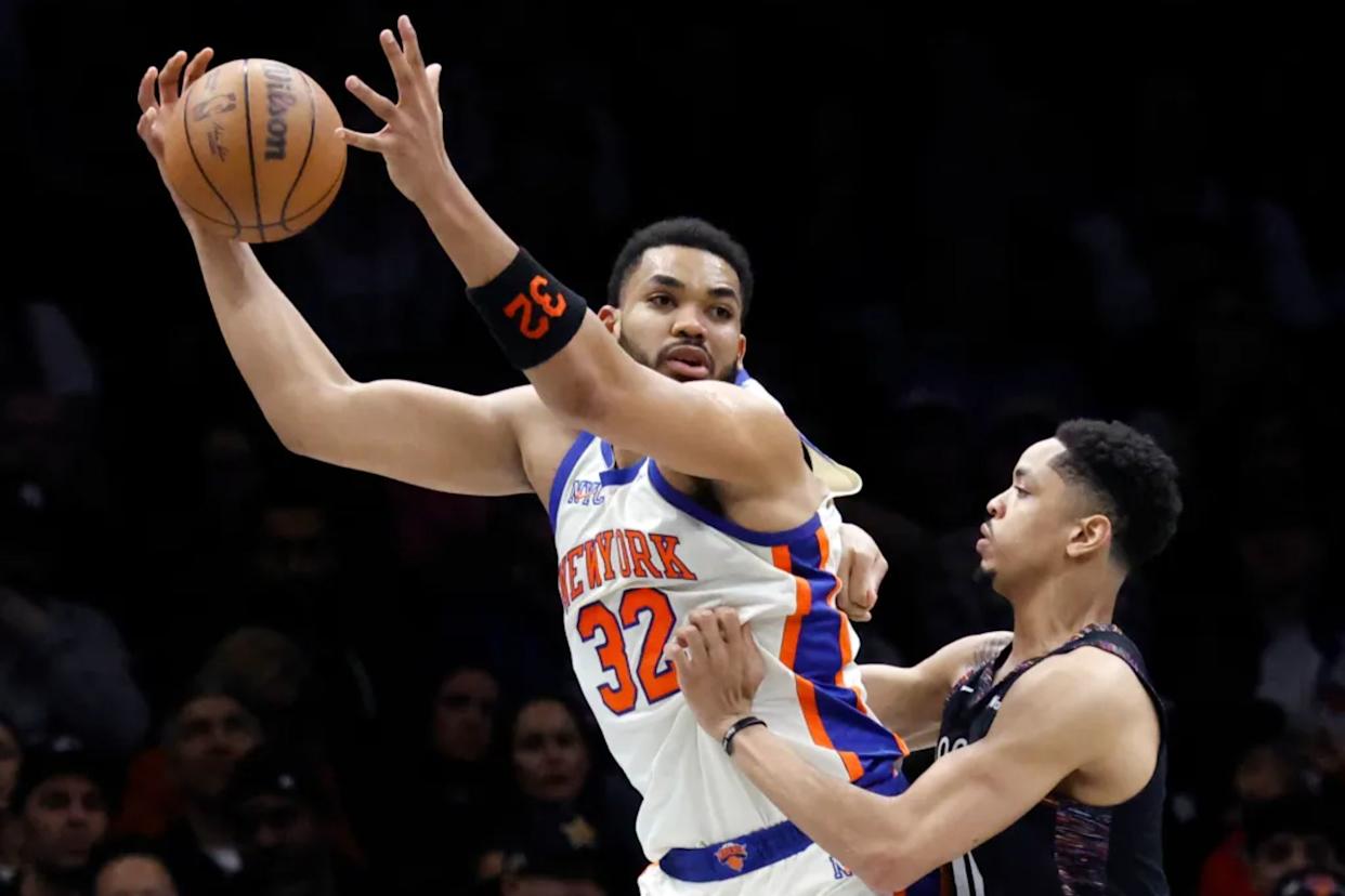 An image collage containing 1 images, Image 1 shows Karl-Anthony Towns, who scored 26 points and grabbed 15 rebounds, looks to make a move on Josh Minott during the Knicks' 93-92 win over the Nets on March 20, 2026 at Barclays Center