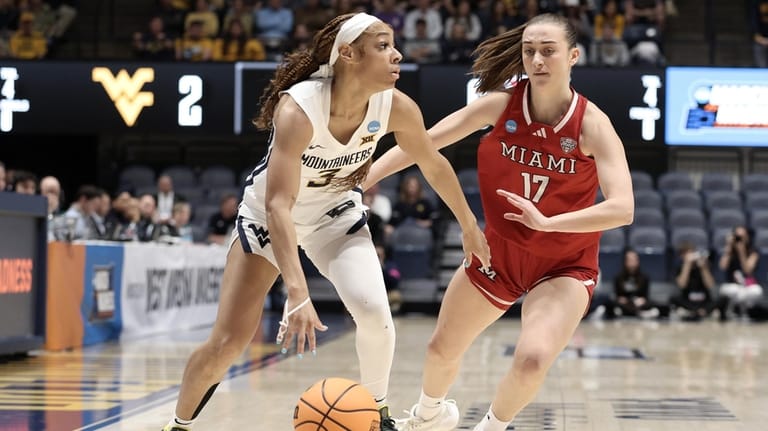 West Virginia guard Gia Cooke (3) is defended by Miami...