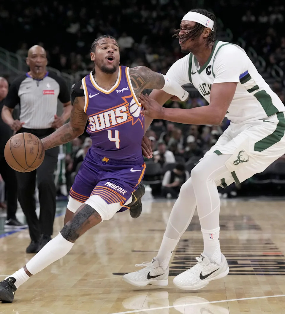 Phoenix Suns guard Jalen Green (4) is guarded by Milwaukee Bucks center Myles Turner (3) during the first half of their game Tuesday, March 10, 2026 at Fiserv Forum in Milwaukee, Wisconsin.
