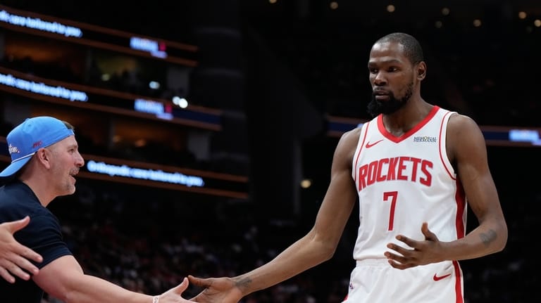 Houston Rockets forward Kevin Durant (7) greets a fan during...