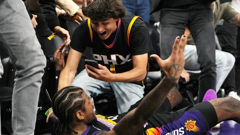 Phoenix Suns guard Jalen Green celebrates with a fan after...