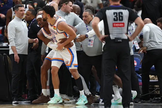 WASHINGTON, DC - MARCH 21: Ajay Mitchell #25 of the Oklahoma City Thunder is pulled out of a scrum of players by teammate Shai Gilgeous-Alexander #2 during the first half at Capital One Arena on March 21, 2026 in Washington, DC. Ajay Mitchell #25 of the Oklahoma City Thunder received a double technical and ejected from the contest. NOTE TO USER: User expressly acknowledges and agrees that, by downloading and or using this photograph, User is consenting to the terms and conditions of the Getty Images License Agreement. (Photo by Patrick Smith/Getty Images)