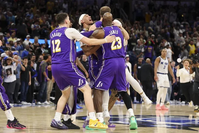 Mar 21, 2026; Orlando, Florida, USA; Los Angeles Lakers guard Luke Kennard (10) reacts with center Jaxson Hayes (11) guard Austin Reaves (15) forward Jake LaRavia (12) and forward LeBron James (23) after hitting a game winning basket at the buzzer against the Orlando Magic in the fourth quarter at Kia Center.