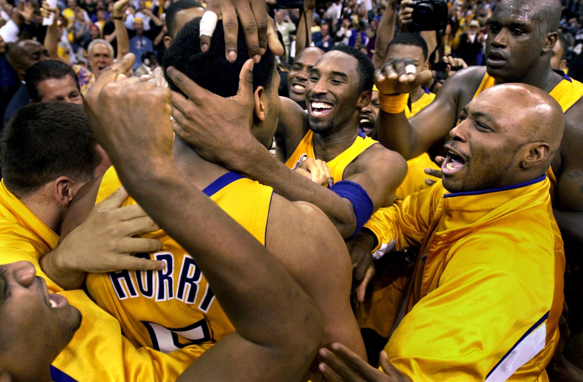 Robert Horry is mobbed at midcourt after hitting winning shot against the Kings in Game 4 of the Western Conference Finals.