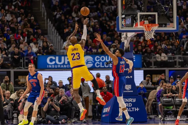 Mar 23, 2026; Detroit, Michigan, USA; Los Angeles Lakers LeBron James (23) shoots the ball over Detroit Pistons Tobias Harris (12) during the second half at Little Caesars Arena.