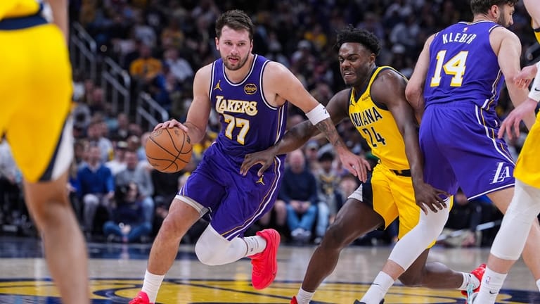 Los Angeles Lakers guard Luka Doncic (77) drives past Indiana...
