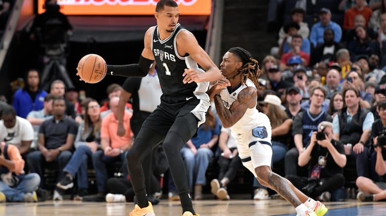 San Antonio Spurs forward Victor Wembanyama (1) handles the ball...