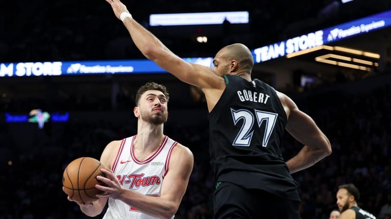 Houston Rockets center Alperen Sengun, left, drives toward the hoop...