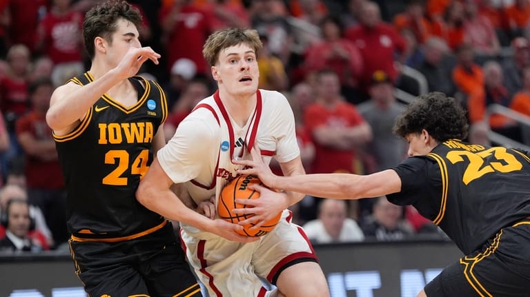 Nebraska forward Braden Frager (5) drives between Iowa guards Tate...