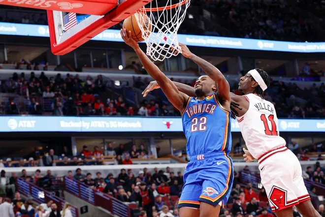 Mar 3, 2026; Chicago, Illinois, USA; Oklahoma City Thunder guard Cason Wallace (22) goes to the basket against Chicago Bulls forward Leonard Miller (11) during the second half at United Center. Mandatory Credit: Kamil Krzaczynski-Imagn Images