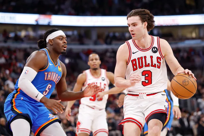 Mar 3, 2026; Chicago, Illinois, USA; Oklahoma City Thunder guard Luguentz Dort (5) defends against Chicago Bulls guard Josh Giddey (3) during the first half at United Center. Mandatory Credit: Kamil Krzaczynski-Imagn Images