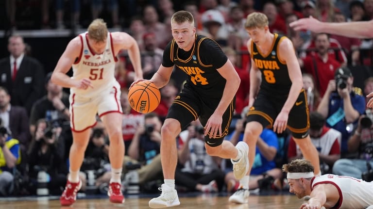 Iowa guard Bennett Stirtz (14) races down court after grabbing...