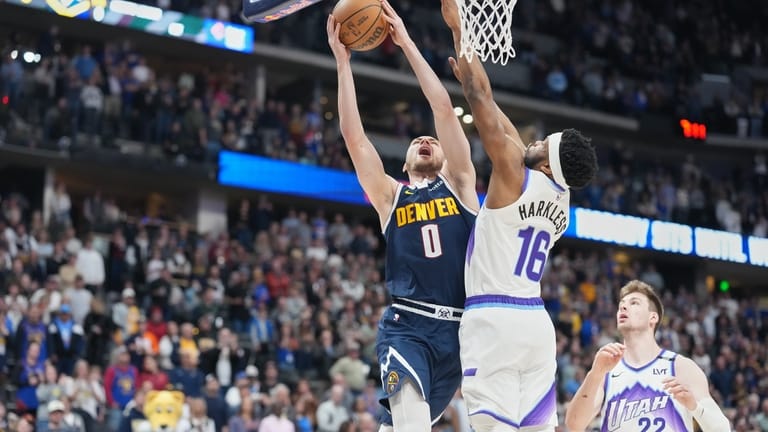 Denver Nuggets guard Christian Braun (0) has his shot blocked...