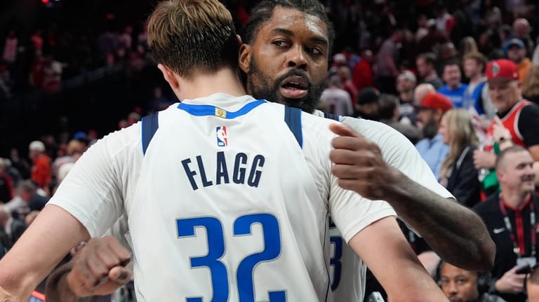Dallas Mavericks forward Cooper Flagg (32) hugs forward Naji Marshall,...