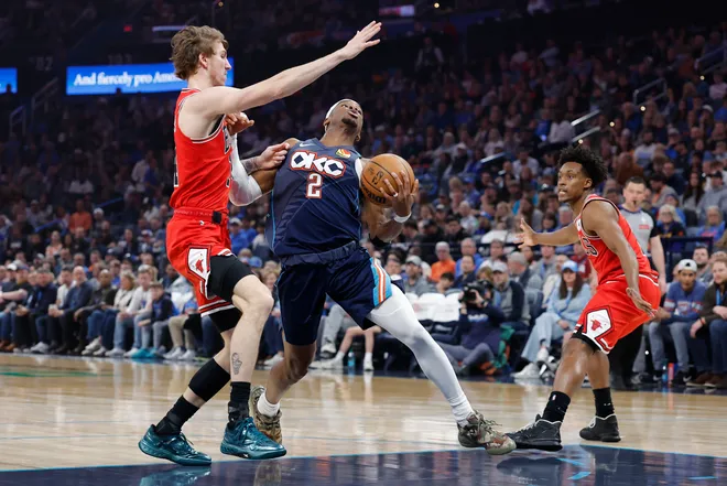 Mar 27, 2026; Oklahoma City, Oklahoma, USA; Oklahoma City Thunder guard Shai Gilgeous-Alexander (2) drives past Chicago Bulls forward Matas Buzelis (14) during the first half at Paycom Center. Mandatory Credit: Alonzo Adams-Imagn Images
