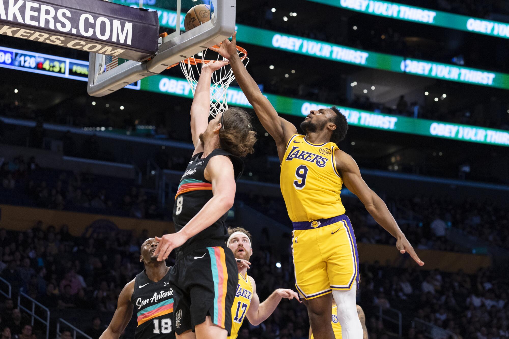 Lakers guard Bronny James blocks a shot by Spurs forward Kelly Olynyk at Crypto.com Arena on Feb. 10.