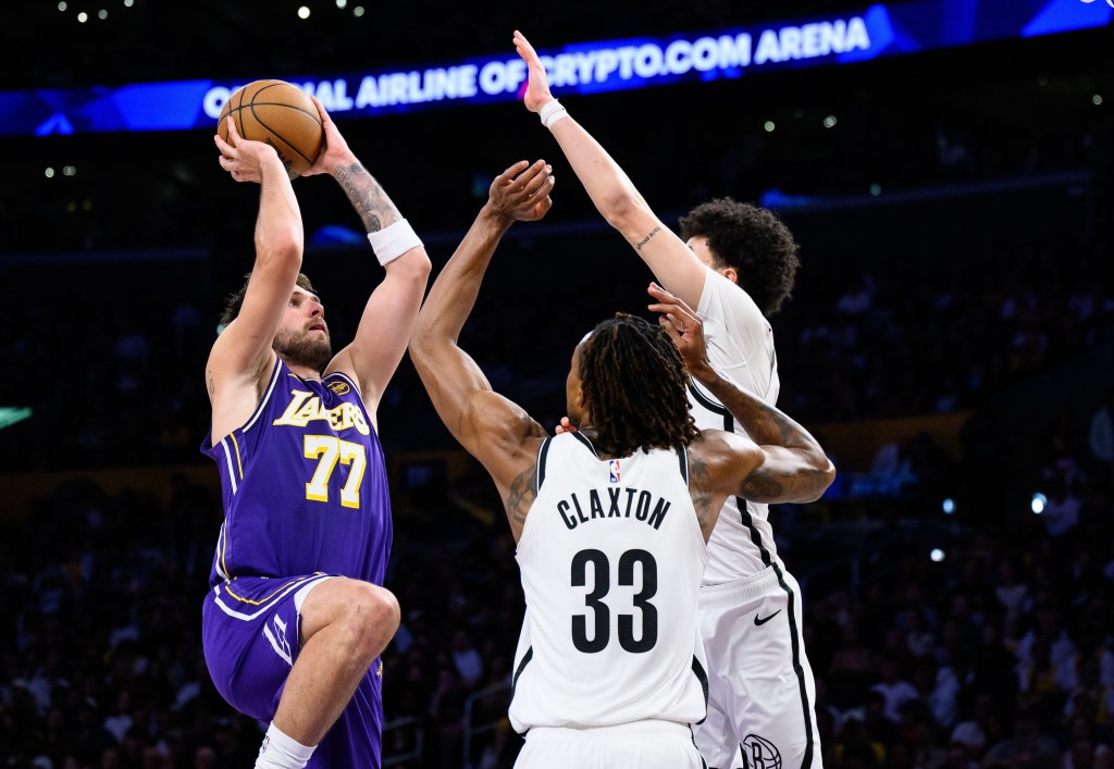 Luka Doncic, who scored 41 points, shoots over Nic Claxton (33) and guard Nolan Traore (88) during the Nets' 116-99 loss to the Lakers on March 27, 2026 in Los Angeles.