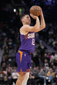 Mar 10, 2026; Milwaukee, Wisconsin, USA; Phoenix Suns guard Collin Gillespie (12) shoots during the fourth quarter against the Milwaukee Bucks at Fiserv Forum. Mandatory Credit: Jeff Hanisch-Imagn Images