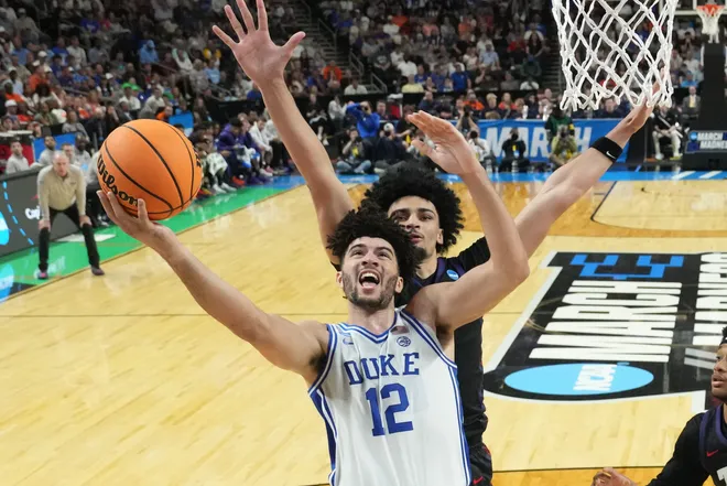Mar 21, 2026; Greenville, SC, USA; Duke Blue Devils forward Cameron Boozer (12) shoots as Texas Christian University Horned Frogs forward David Punch (15) defends in the second half during a second round game of the men's 2026 NCAA Tournament at Bon Secours Wellness Arena. Mandatory Credit: Bob Donnan-Imagn Images