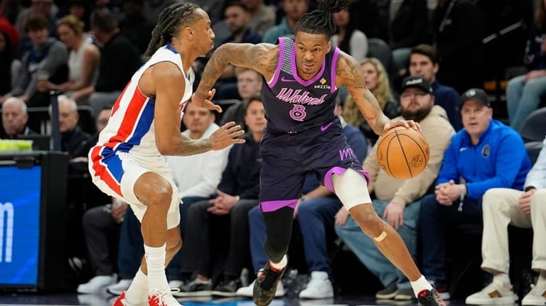 Minnesota Timberwolves guard Bones Hyland (8) works around Detroit Pistons...