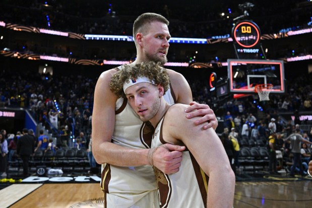 Golden State Warriors center Kristaps Porzingis (7) hugs teammate Brandin Podziemski (2) after defeating the Washington Wizards during their NBA game at Chase Center in San Francisco, Calif., on Friday, March 27, 2026. The Golden State Warriors defeated the Washington Wizards 131-126. (Jose Carlos Fajardo/Bay Area News Group)