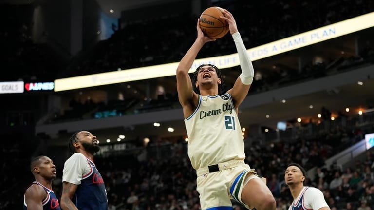 Milwaukee Bucks' Ousmane Dieng (21) shoots during the second half...