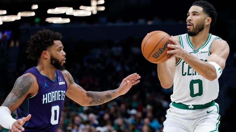 Boston Celtics forward Jayson Tatum (0) looks to shoot against...