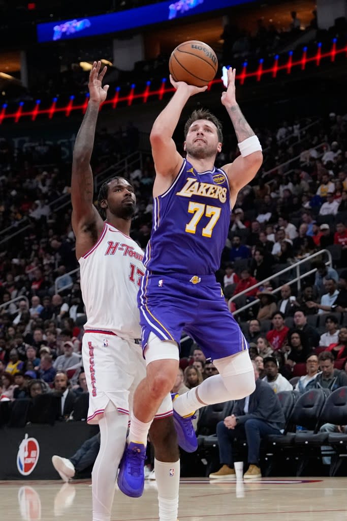 Los Angeles Lakers’ Luka Doncic shoots as Houston Rockets’ Tari Eason defends during the second half of an NBA basketball game Wednesday, March 18, 2026, in Houston. (AP Photo/David J. Phillip) AP