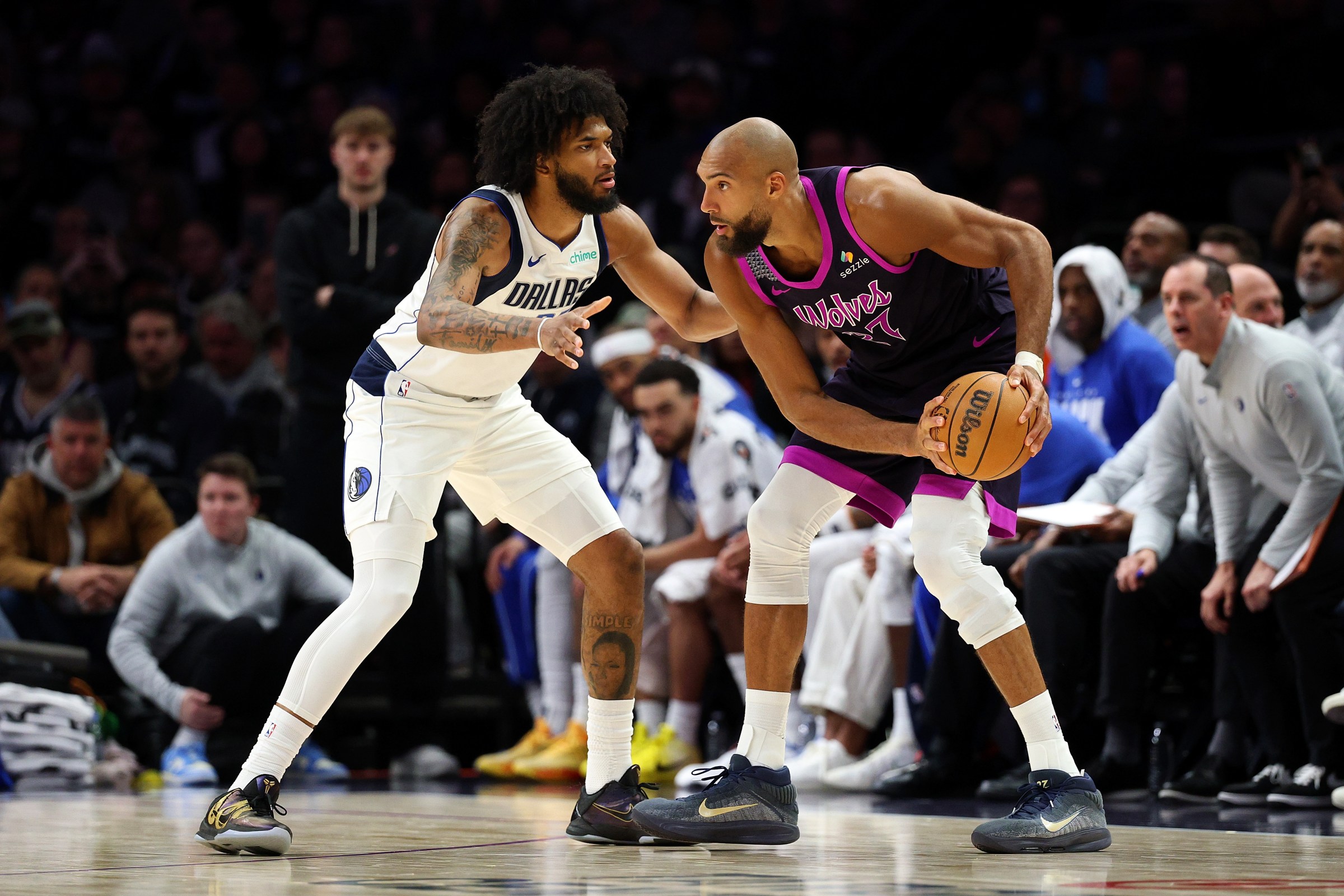 MINNEAPOLIS, MINNESOTA - FEBRUARY 20: Rudy Gobert #27 of the Minnesota Timberwolves handles the ball against Marvin Bagley III #35 of the Dallas Mavericks in the third quarter at Target Center on February 20, 2026 in Minneapolis, Minnesota. The Timberwolves defeated the Mavericks 122-111. NOTE TO USER: User expressly acknowledges and agrees that, by downloading and or using this photograph, User is consenting to the terms and conditions of the Getty Images License Agreement. (Photo by David Berding/Getty Images)