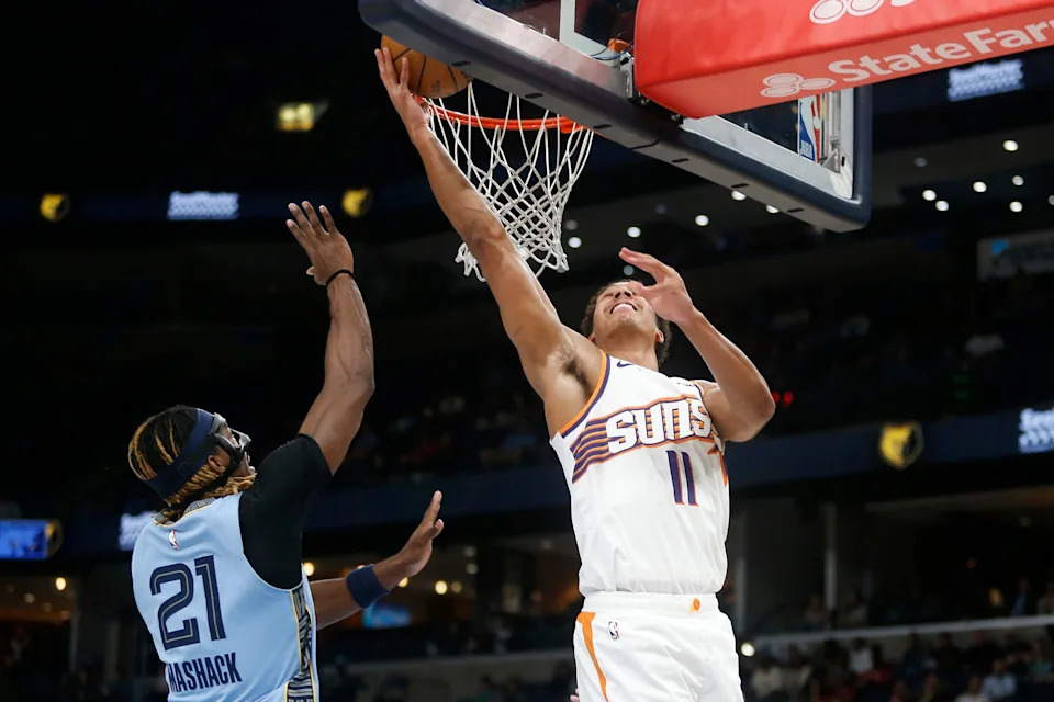 Phoenix Suns forward Oso Ighodaro (11) shoots as Memphis Grizzlies guard Jahmai Mashack (21) defends during the first quarter at FedExForum on March 30, 2026.