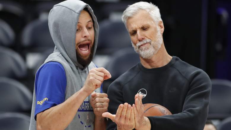 Stephen Curry #30 of the Golden State Warriors prepares for warm-up with assistant coach Bruce Fraser
