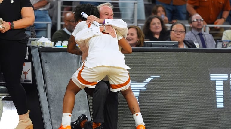 Texas guard Rori Harmon (3) hugs head coach Vic Schaefer...