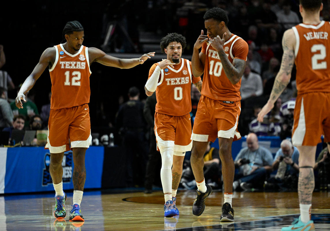 Texas Longhorns guard Tramon Mark (12), guard Jordan Pope (0) and forward Nic Codie (10) react after a play.© Troy Wayrynen-Imagn Images